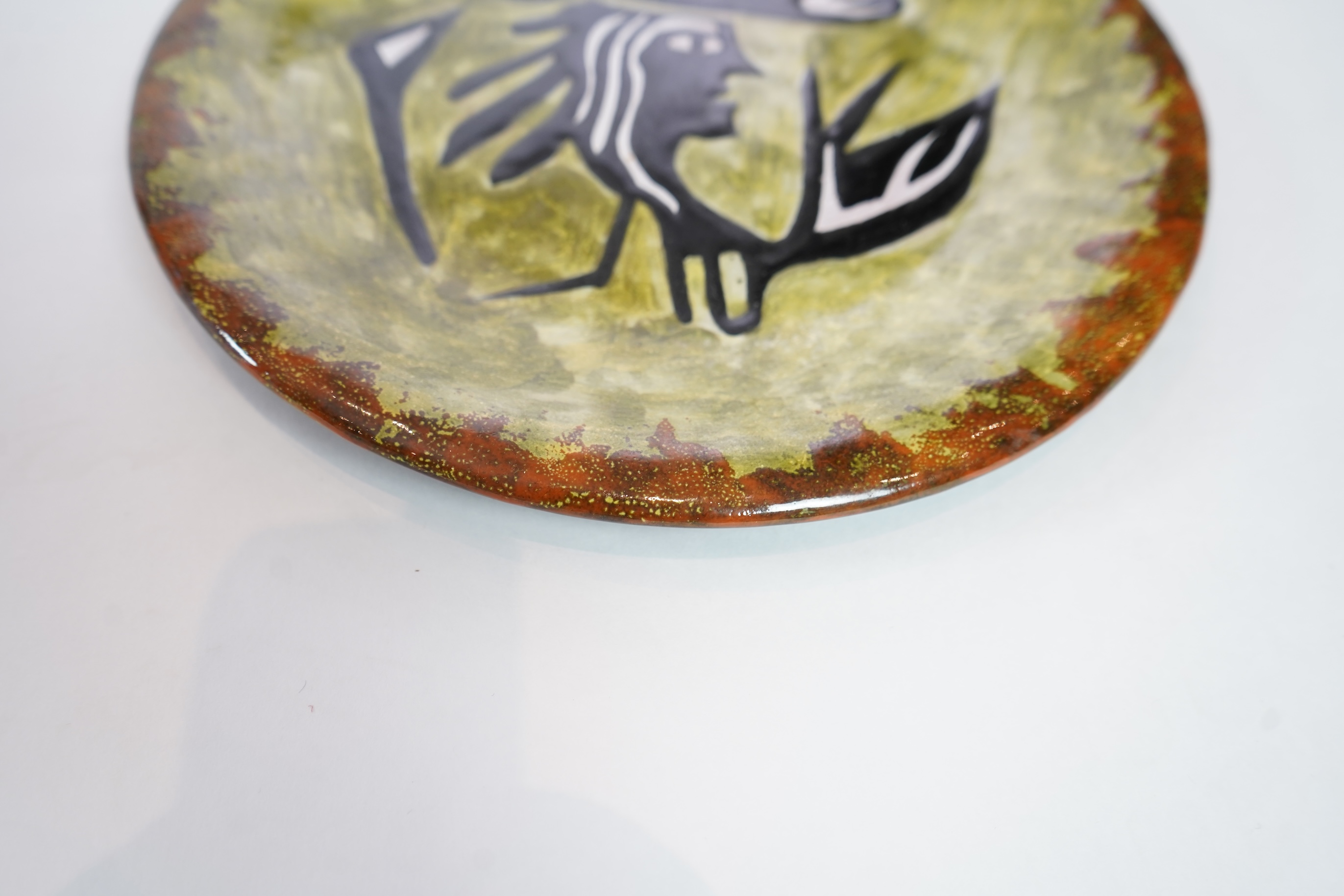 Jean Lurçat (1892-1966): A green glazed earthenware plate, decorated with a stylised central figure